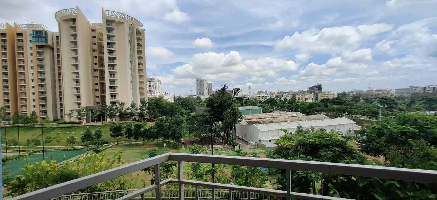 Apartment towers among trees, seen from a balcony in Bengaluru