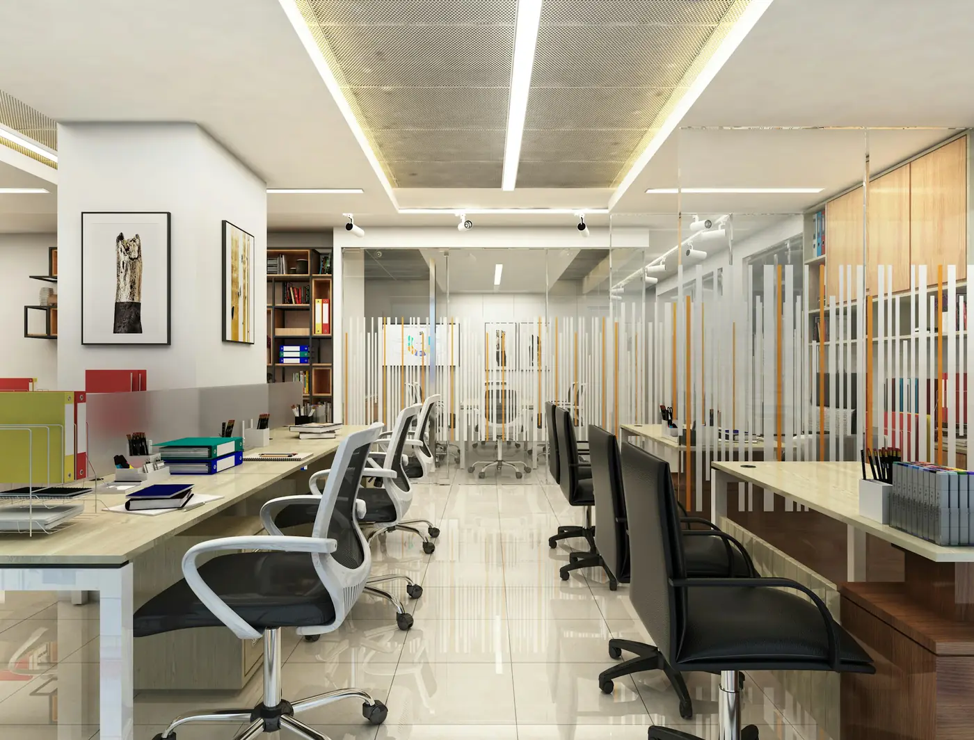 An open-plan office with rows of desks and glass cabins